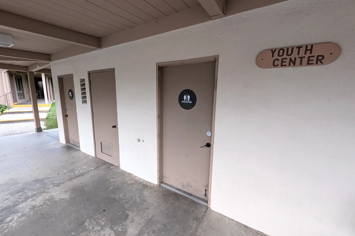 The covered campus walkway beside the Youth Center sign