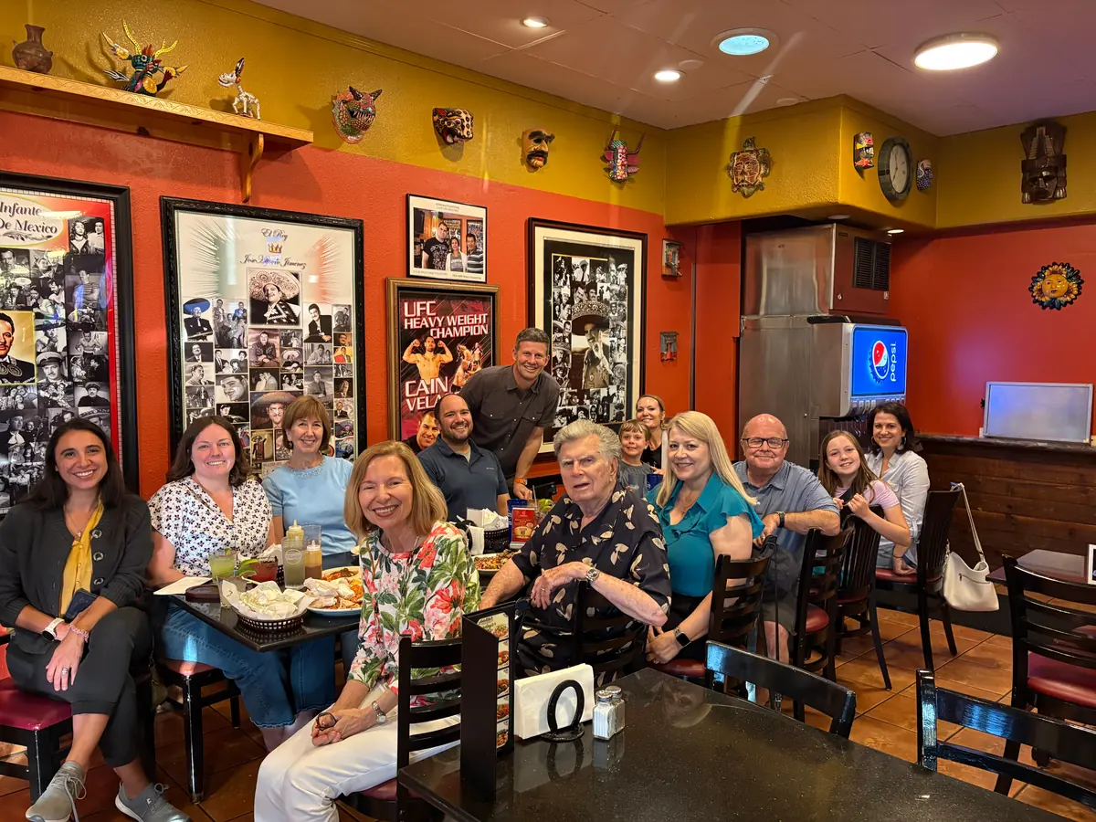 PCLG friends gathered around a restaurant table.