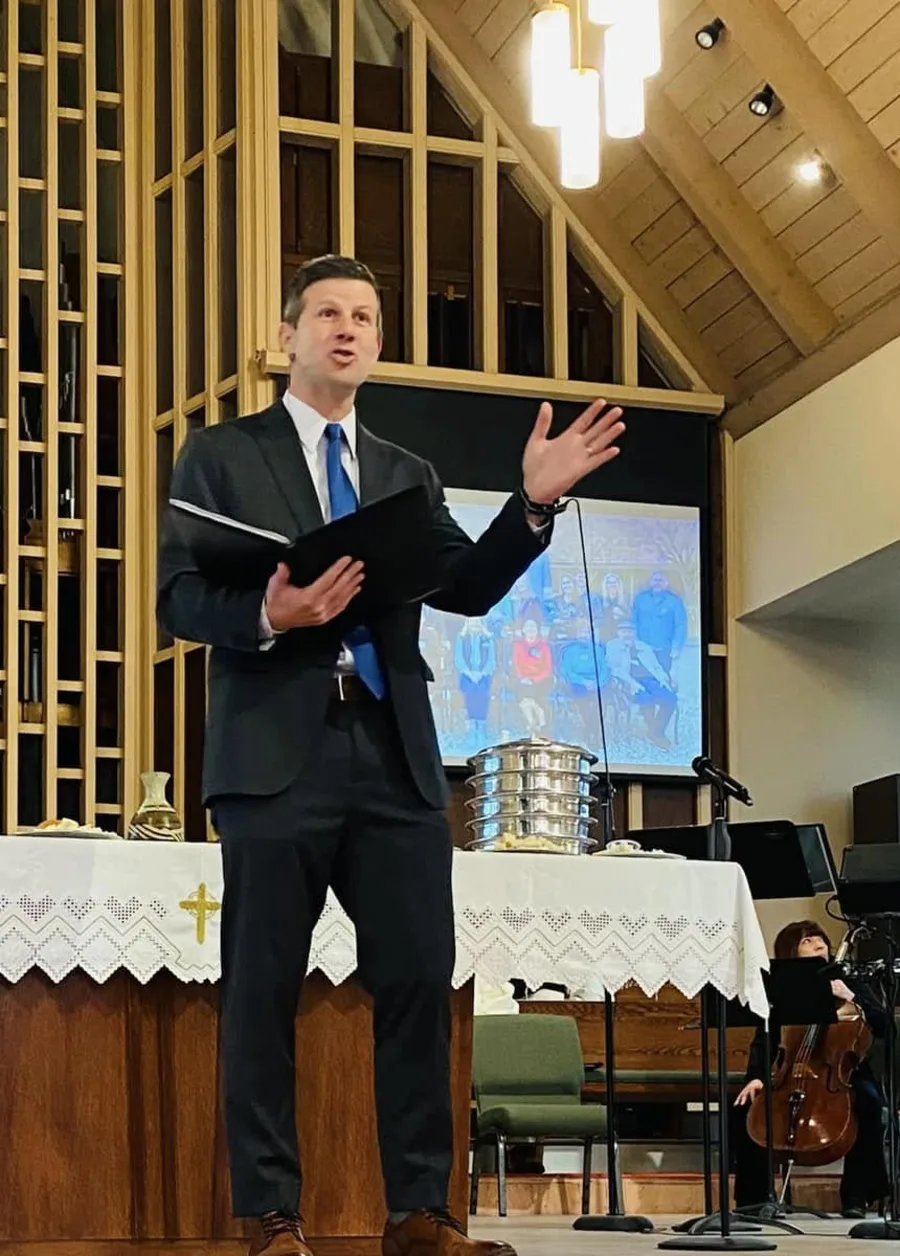 The Rev. Dr. David G. Watermulder speaking from the chancel in the PCLG Sanctuary.