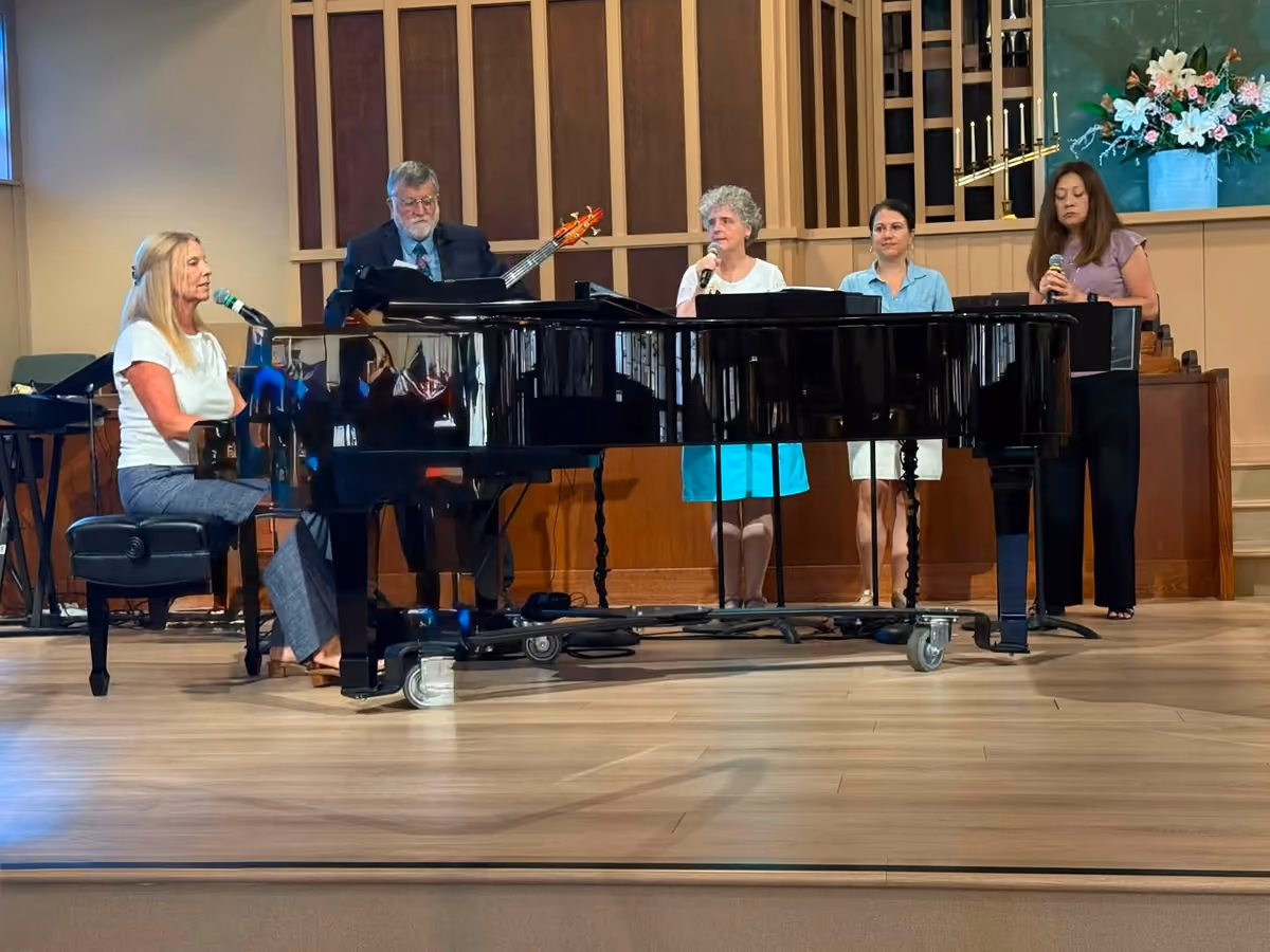 PCLG’s worship band leading music with piano, bass, and singers.