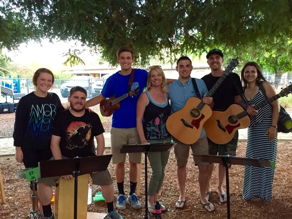 Members of the PCLG Worship Band with guitars and microphones.